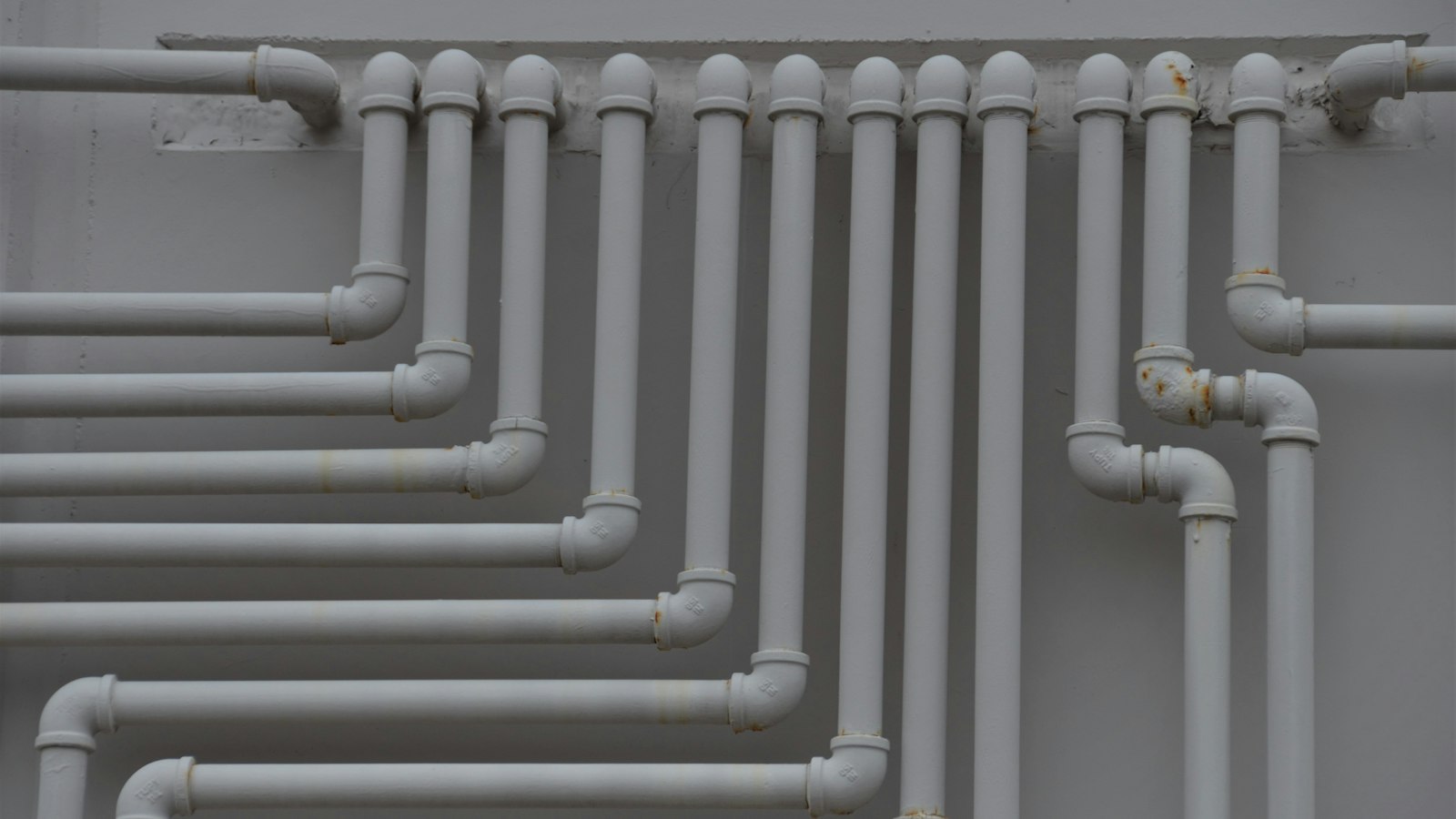 A close up of a bunch of pipes on a wall