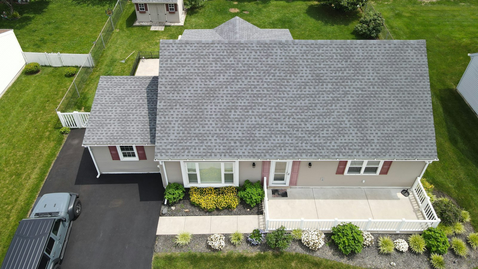 Aerial view of a suburban house with a grey roof